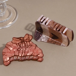 Pink and amber acetate hair claws with marble and tortoiseshell patterns for women