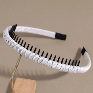 Detailed macro view showing the woven silk satin texture and non-slip inner teeth of the headband