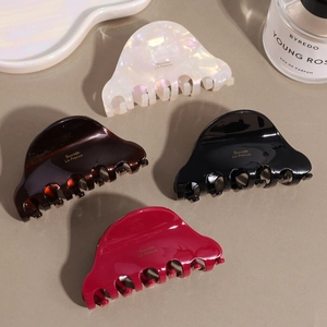 French style acetate hair claws in white, brown, black and red with gold lettering