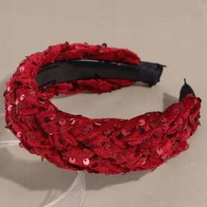 Detail of red velvet braided headband featuring sparkling sequins and comfortable fabric ends