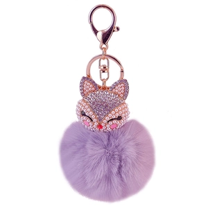 Purple faux fur pom pom keychain with fox head design and sparkling crystals