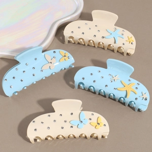 Set mit vier blau-beigen Seestern-Haarklammern aus Acetat mit kleinen Strasssteinen