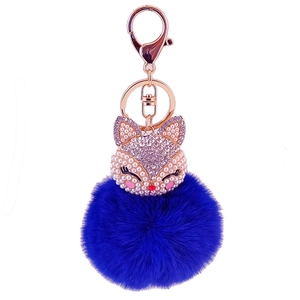 Royal blue faux fur pompom keychain with crystal fox head charm in rose gold finish
