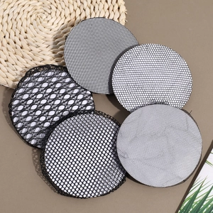 Detail view of five black lace hair nets with different mesh sizes for bun styling