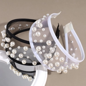 Set of two wide mesh headbands with pearls in black and white colors on a grey background