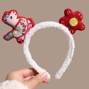 Detail of red lamb wool headband featuring a cute cartoon deer and traditional embroidery