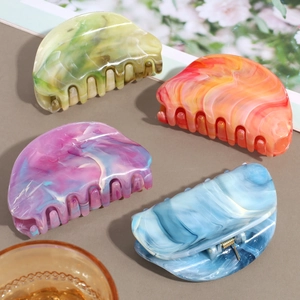 Elegant marble pattern hair claws in assorted pastel colors for hair styling