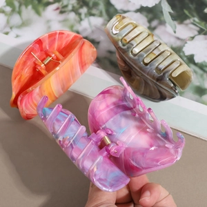 Marbled geometric hair claw clips in coral, brown, and blue for thick hair styling