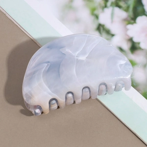 Detail of blue marble pattern hair claw clip made of acetic acid resin material