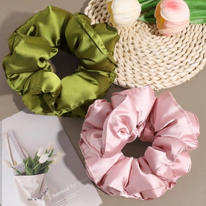 Pair of large satin scrunchies in olive green and dusty pink with elegant silk luster