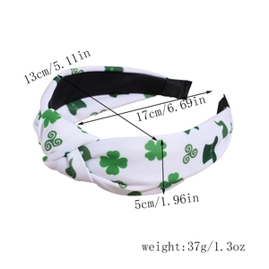 Detail of St. Patrick's Day knotted headband featuring green shamrocks and leprechaun hats