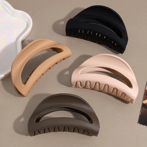 Minimalist matte shark hair clips in earth tones on a neutral background