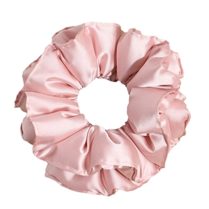 Pink satin scrunchie with soft silk texture and ruffled wave edges for hair styling