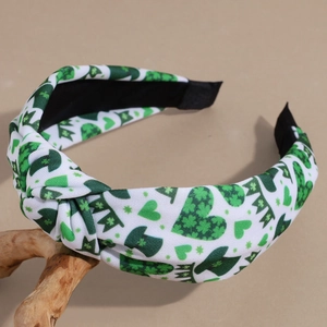 Detail of St. Patrick's Day knotted headband with green clover and leprechaun hat patterns