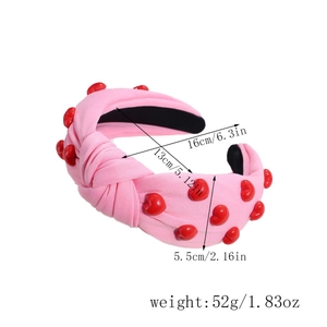 Pink knotted headband with red heart beads showing 16cm outer and 13cm inner diameter