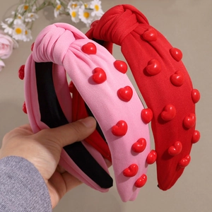 Pink and red knotted headbands with 3D heart embellishments for Valentine's Day