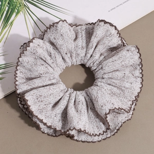 Knitted beige scrunchie with brown wavy edges and retro textured fabric style