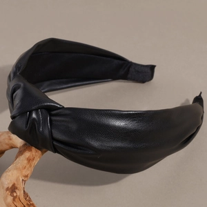 Close-up of black faux leather headband featuring an elegant twisted knot design