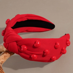 Red top knot headband with 3D heart beads on a minimalist knitted fabric design