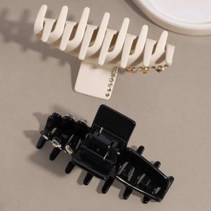 Luxurious medium water-drop hair claws in black and beige with sparkling rhinestones