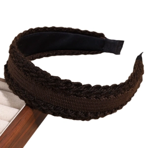 Retro thick knit twist headband in dark brown displayed on a professional wooden stand