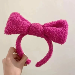 Close-up of fluffy rose red sherpa bow headband with soft plush texture and wide band