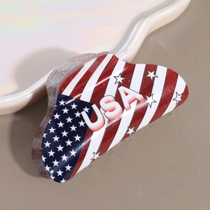 Close-up of USA flag mini hair claw clip with glitter finish and bold white text
