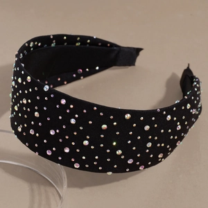 Detail shot of black wide sponge headband featuring colorful rhinestones on satin fabric