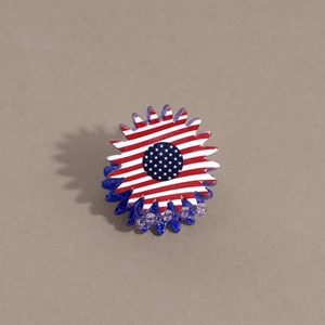 Macro view of sunflower hair claw with US flag stars and stripes pattern and blue glitter