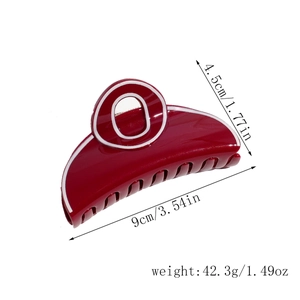 Detailed view of deep red glossy hair claw clip with dimensions 9cm by 4.5cm