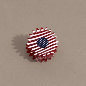 Macro detail of sun flower hair claw clip with American flag pattern and red glitter