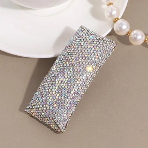Detail of elegant rhinestone hair clip with iridescent AB crystals on silver metal