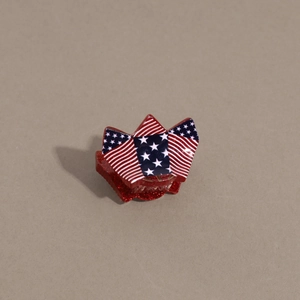 Detail of USA flag pattern hair claw clip with red glitter stars and stripes design