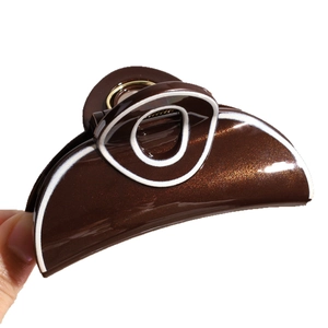 Minimalist brown shark hair claw with white rim design and glossy metallic finish