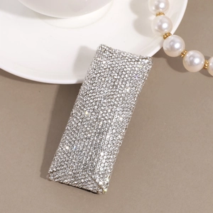 Close-up of elegant silver hair clip fully encrusted with sparkling clear rhinestones