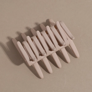 Detailed macro view of large matte nude resin hair claw clip with sturdy rectangular hollow design