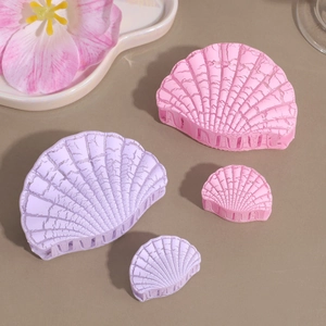 Detail of flower shell hair clips in pink and purple with realistic crackle texture finish
