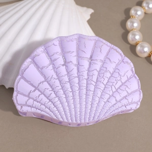 Detailed view of lavender seashell hair claw with unique crackle texture and gloss finish