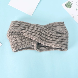 Grey knitted twisted headband for women with a warm ribbed texture for winter style
