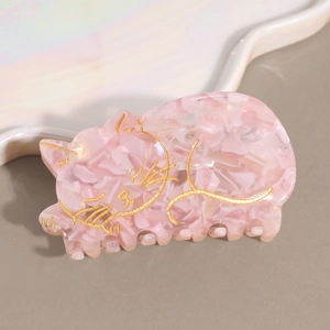 Détail de la pince à cheveux chat en acétate rose marbré avec contours dorés fins