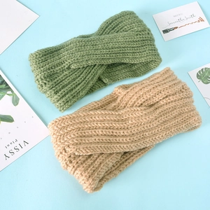 Detailed close-up showing the ribbed knitted texture and knot of green and tan headbands