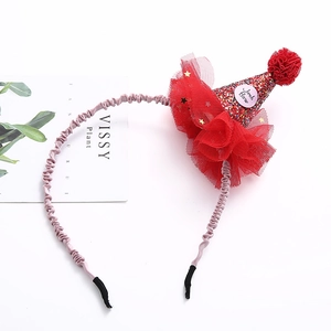 Detail of red sequined party hat headband with gold stars and soft tulle ruffles