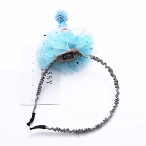 Macro shot of a light blue mesh birthday hat headband with sparkling sequin stars