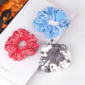 Three-piece paisley print scrunchie set in red, blue, and cream cotton fabric