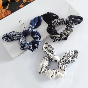 Three-piece paisley print scrunchies with rabbit ear knots in navy, black, and beige colors