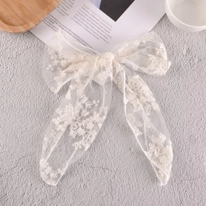 Elegant white lace bow hair clip with delicate floral embroidery in French chic style