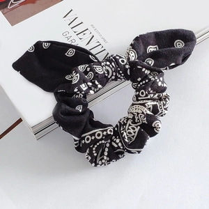 Detail of black and white bohemian paisley print scrunchie with a stylish bunny ear bow