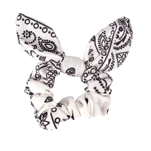 Bunny ear scrunchie with classic black and white paisley floral print on plain background