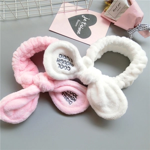 Plush bunny ear headbands in pink and white for skincare and makeup routines