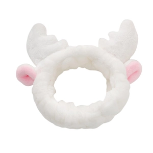 Detailed view of plush white deer antler headband with soft pink coral fleece texture